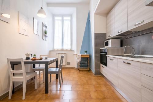 a kitchen with a table and a dining room at Travel & Station Apartament in Livorno