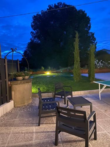 a group of benches sitting on a patio at night at Sul VenTo del Po in Melara