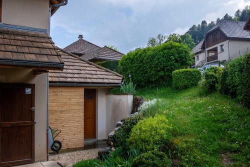 a house with a grassy yard next to a building at guesthome la petite salette in Monestier-de-Clermont