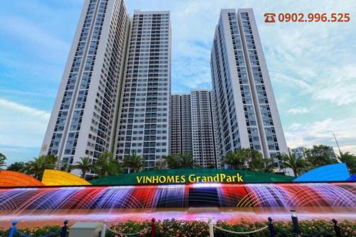 two tall buildings with a sign in front of them at Homestay Sài Gòn-Vinhomes Grand Park Quận 9-Plus 2PN in Long Bình