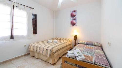 Säng eller sängar i ett rum på Los Lirios Jimera de Libar by Ruralidays