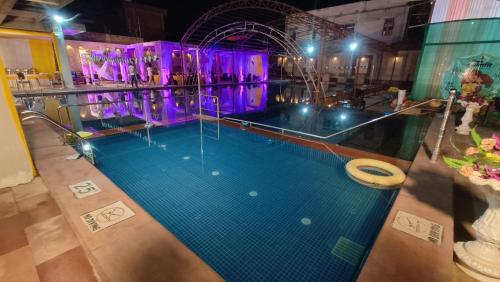 an indoor swimming pool with a pool at Ratna Hotel & Banquet in Muzaffarpur