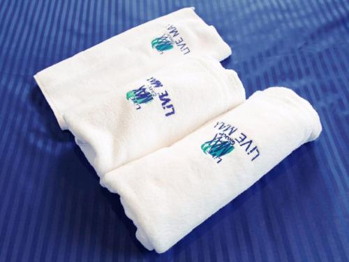 a pair of white socks with the words happy new year at HOTEL LiVEMAX Saitama-Asaka-Ekimae in Asaka