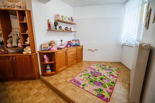 a kitchen with a refrigerator and a rug on the floor at Apartments Vila Lena at Aqualuna in Podčetrtek