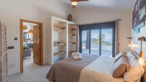 a bedroom with a bed with a view of the ocean at Villa Isabella Cómpeta by Ruralidays in Cómpeta