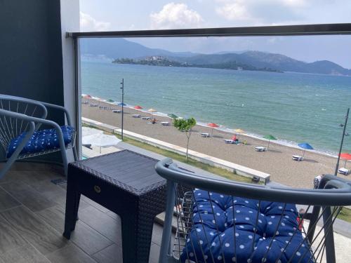 a balcony with a view of a beach and the ocean at Olimpia Hotel in Fethiye