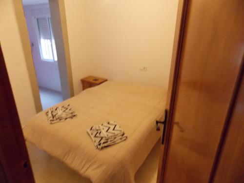 a small bedroom with a bed with white sheets at Fortuna Villa 510 in Mazarrón