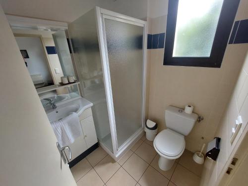 a bathroom with a shower and a toilet and a sink at Chez Terrassier - Logis Hôtels - Hotel et Restaurant in Vaissac