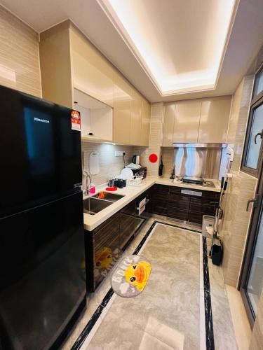 a kitchen with a glass floor in the middle at R&F PRINCESS COVE at ANJU in Johor Bahru