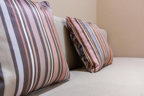 two pillows sitting on top of a bed at Marchese 25 Apartments in Bari