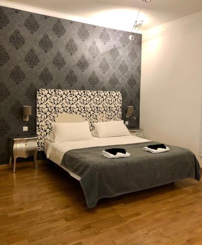a bedroom with a bed with two towels on it at Dolce Vita Suites Boutique in Prague
