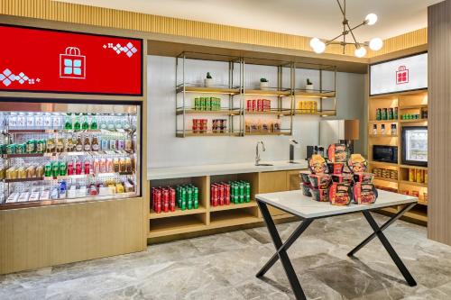 a grocery store with a counter and a table with food at Hilton Garden Inn Zhuhai Jinan University in Zhuhai
