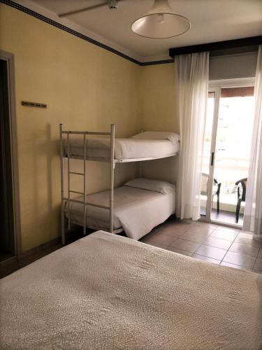 Ένα ή περισσότερα κρεβάτια σε δωμάτιο στο Le Petit Hotel