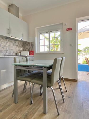 a dining room table and chairs in a kitchen at Serra mar in Cruz de João Mendes
