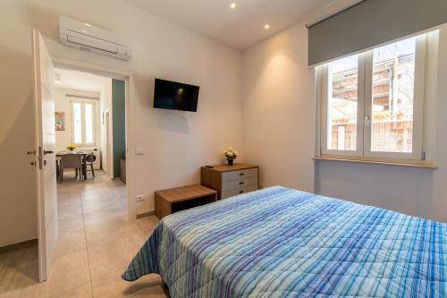 a bedroom with a bed and a window and a table at Villa Gina Case Vacanze in Roseto degli Abruzzi
