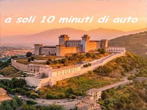 a castle on top of a hill with the words a soil minuthi at LE CERQUE in Spoleto