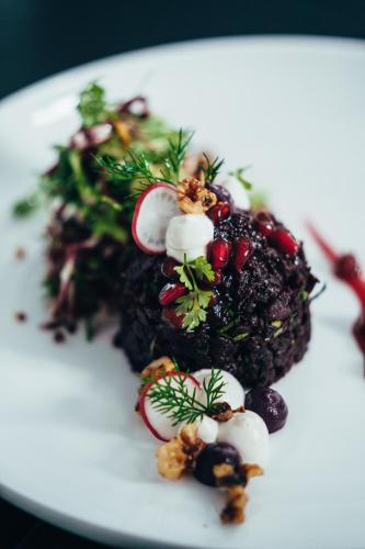 a white plate with a piece of food on it at Hotel Riesengebirge in Neuhof an der Zenn