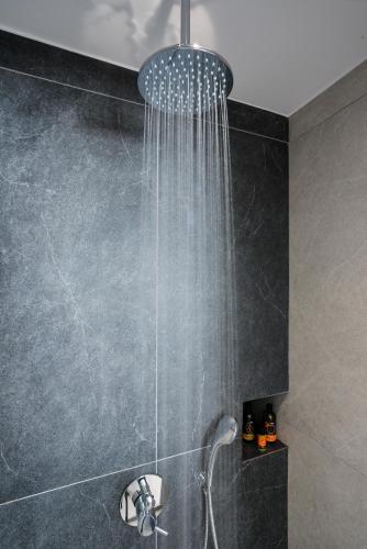 a shower with a shower head in a bathroom at Casa Manolesos in Chorafakia