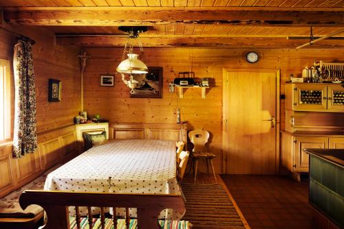 ein Schlafzimmer mit einem Bett in einer Holzhütte in der Unterkunft Jörgenbauerhütte in Spital am Pyhrn