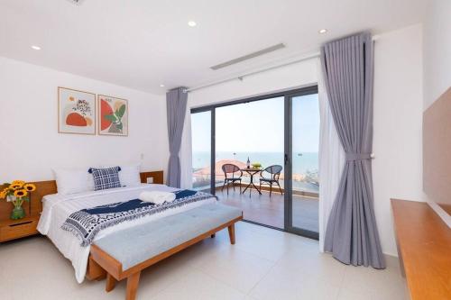 a bedroom with a bed and a view of the ocean at Trần Phú Villa Sea View in Vung Tau