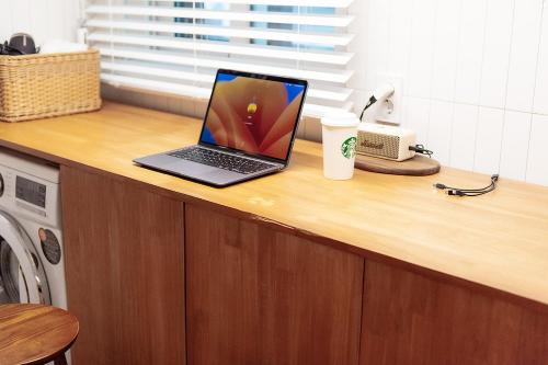 a laptop computer sitting on top of a counter at Hostel Mihojae Busan in Busan