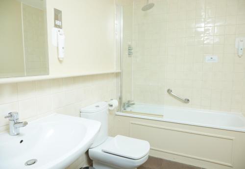 a bathroom with a toilet and a sink and a shower at Trents by Greene King Inns in Chichester