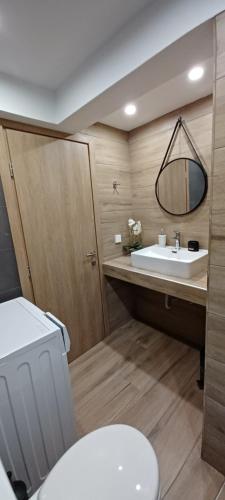 a bathroom with a white toilet and a sink at Seaview Luxury Apartment in Mytilini