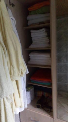 a closet filled with white towels and towels at DONNA in Tsinsopʼeli