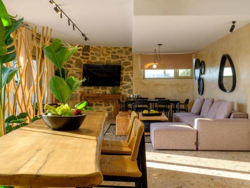 a living room with a table and a couch at Vrachos Suites Mykonos in Mýkonos City