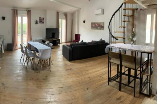 un salon avec un canapé noir et une table dans l'établissement Maison de ville, à Sète