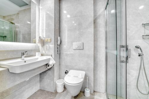 a bathroom with a sink and a toilet and a shower at Kahya Hotel in Alanya