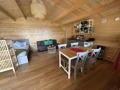a room with a table and chairs in a cabin at Cabañas by Torre de Arriba in Benimantell