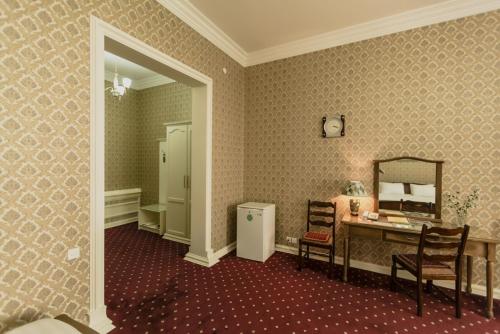 a room with a vanity and a mirror and a desk at Konstantin Hotel in Samarkand