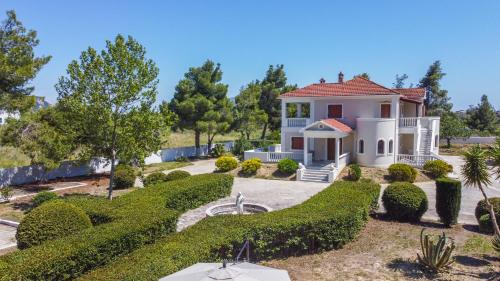 a house with a garden in front of it at Adriana di Levante by "elite" in Ayios Kirikos