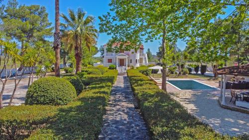 a house with a garden and a swimming pool at Adriana di Levante by "elite" in Ayios Kirikos