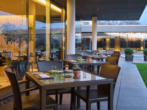 a restaurant with tables and chairs in a building at The Europe Hotel & Resort in Killarney