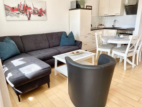 a living room with a couch and a table at Wohnpark Stadt Hamburg - Apt. 50 in Binz