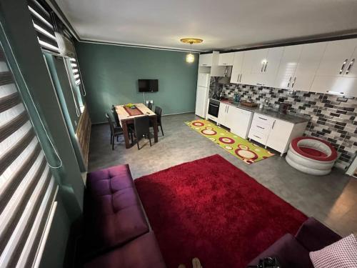 - un salon avec une table et un tapis rouge dans l'établissement FERIENWOHNUNG-HOLIDAY APARTMENT-KVARTIRA internet free, à Belek