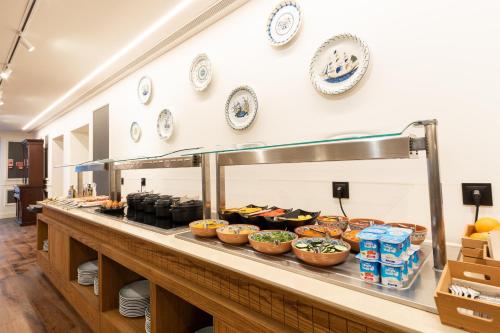 a buffet line with many different types of food at AP Dona Aninhas in Viana do Castelo
