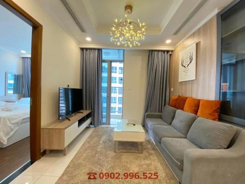 a living room with a couch and a tv at Vinhomes Grand Park Quận 9-Bống House in Long Bình