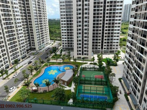 an aerial view of a pool in a city with tall buildings at Vinhomes Grand Park Quận 9-Bống House in Long Bình