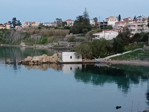 a small house in the middle of a body of water at Seaview Luxury Apartment with private parking in Mytilini