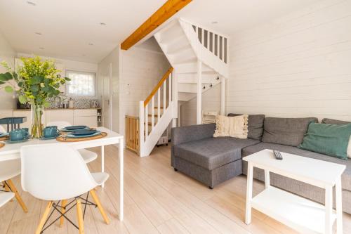 a living room with a couch and a table at Apartamenty Tęsknoty 10 in Dziwnów