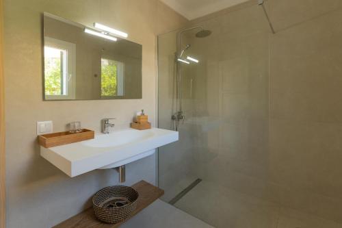 a bathroom with a white sink and a shower at Villa Cristina in Cala d´Or