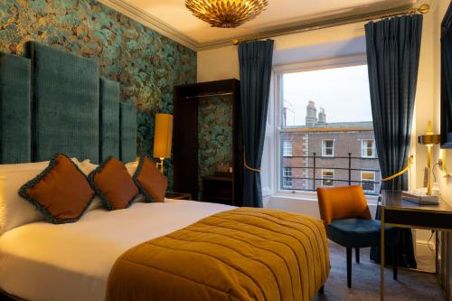 a hotel room with a bed and a desk and a window at Number 31 in Dublin