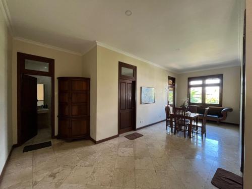 a living room with a table and a dining room at KUTA - 4BR Villa with Private XL Pool in Kuta