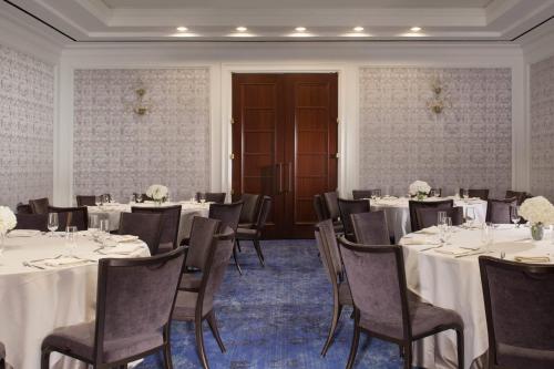 a banquet room with tables and chairs with white tablecloths at The Ritz-Carlton, Dallas in Dallas