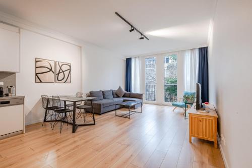 Homie Suites - Luxury Apartments in Maçka في إسطنبول: غرفة معيشة مع أريكة وطاولة