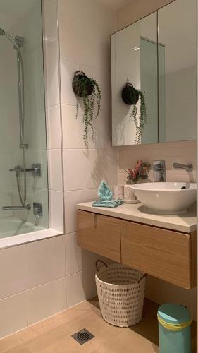 a bathroom with a sink and a mirror at Darwin Waterfront Luxury Condo in Darwin