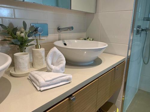 a bathroom with a bowl sink and a shower at Darwin Waterfront Luxury Condo in Darwin